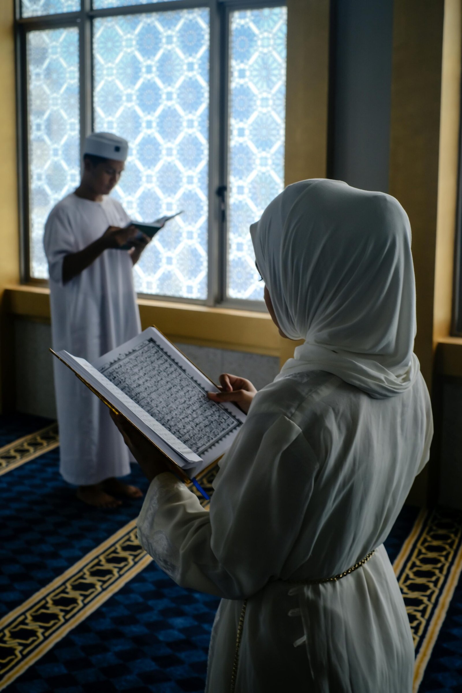 Muslim husband and wife reading Quran together in mosque strengthening their Islamic marriage