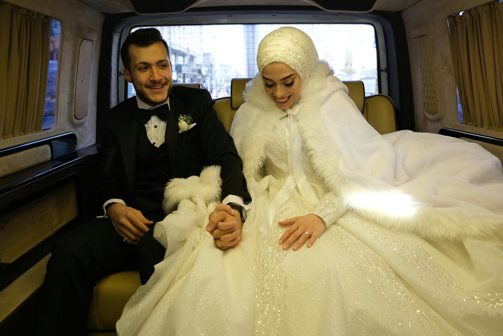 Married Muslim Couple in wedding clothes sitting in a car on the way to thier nikah ceremony