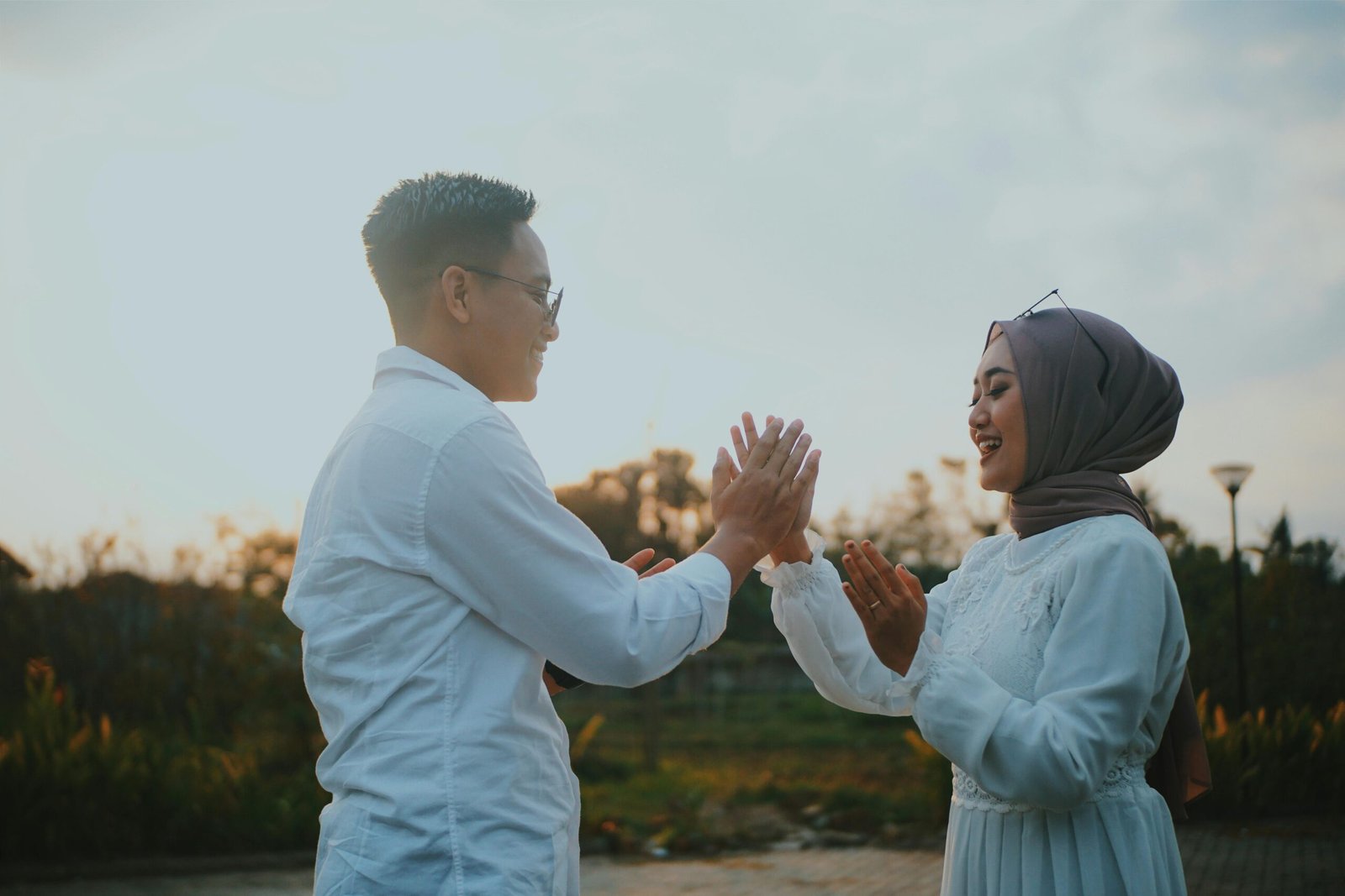Modern Muslim couple smiling outdoors representing successful halal matrimony